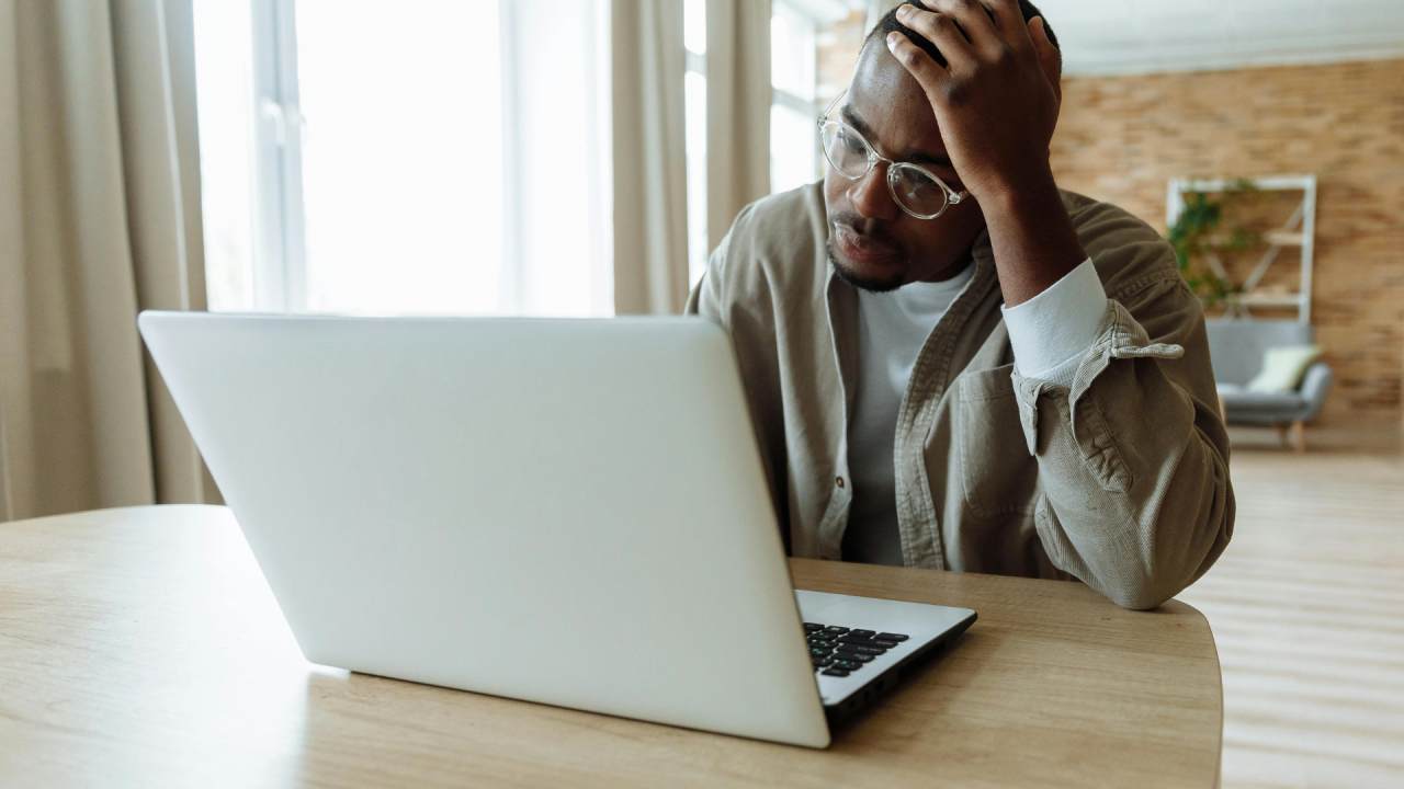 Black man looking at laptop screen